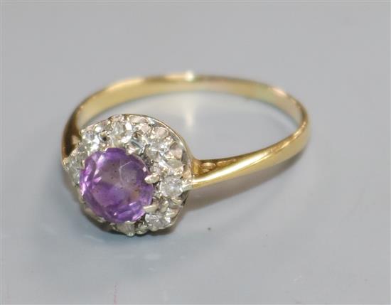 An early-mid 20th century yellow metal, amethyst and diamond set cluster ring, size P.